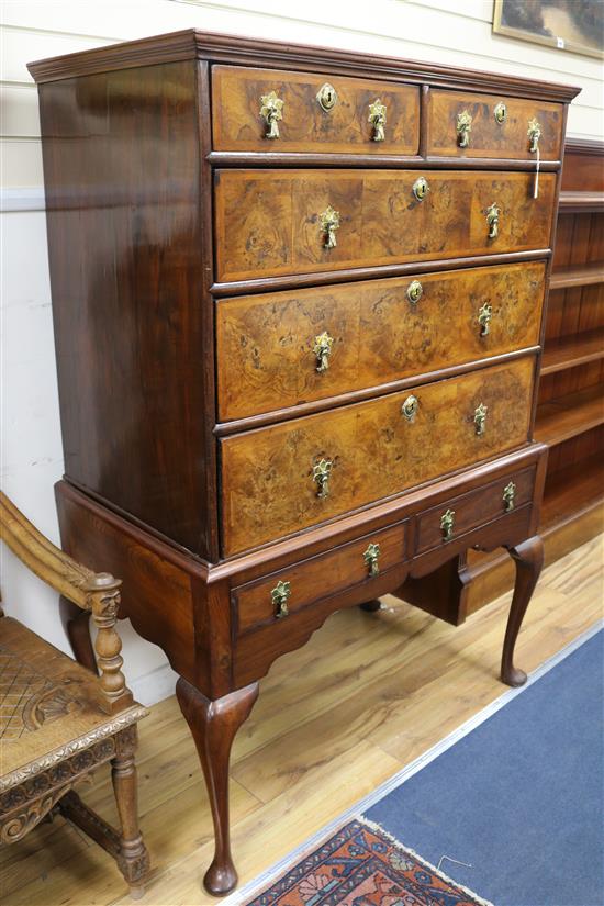 A George II featherbanded walnut chest on later stand, W.3ft 7in. D.2ft H.5ft 1in.